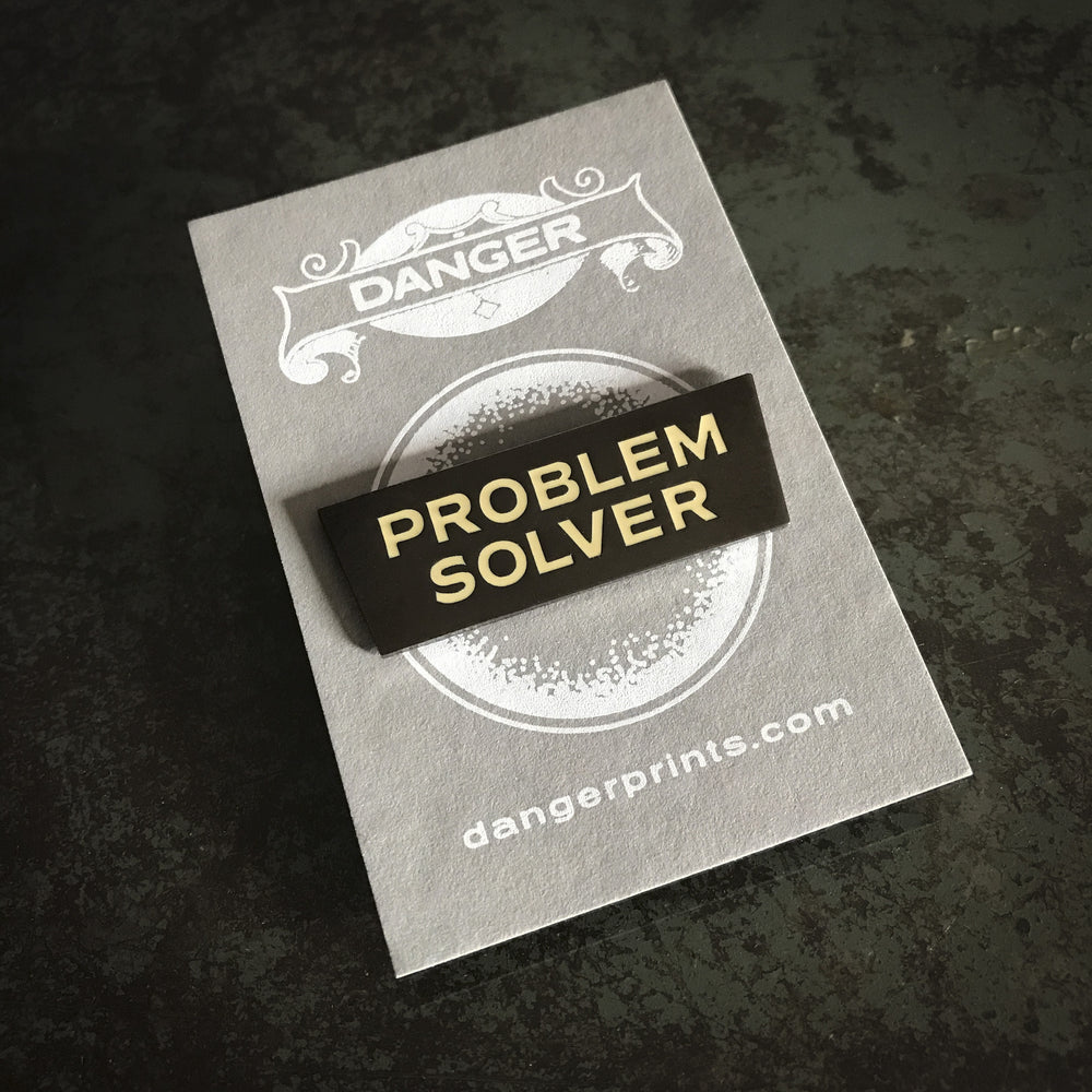 Problem Solver Pin (Nickel with white letters)